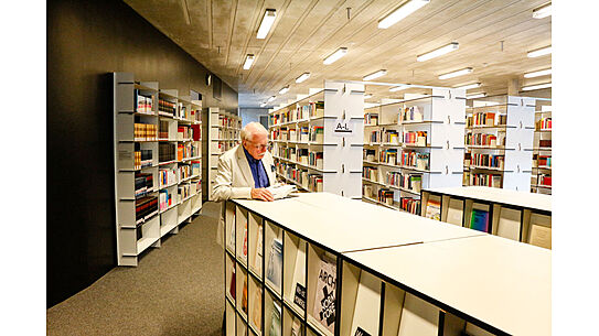 Eine lesende Person in der Bibliothek 